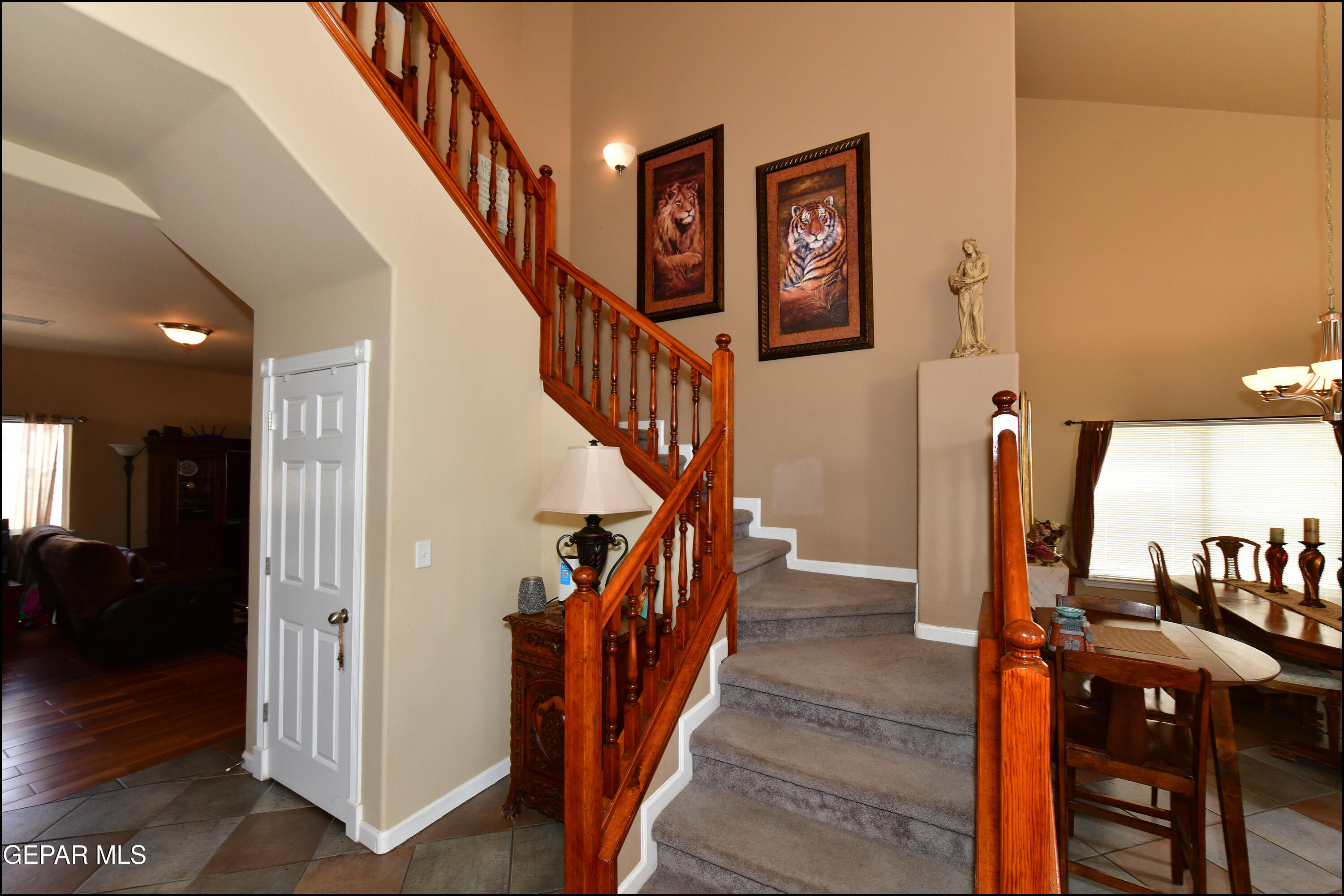 7350 Navidad Way Canutillo, TX 79835 - Photo 22 of 49 a view of staircase with lots of frames on wall and wooden floors