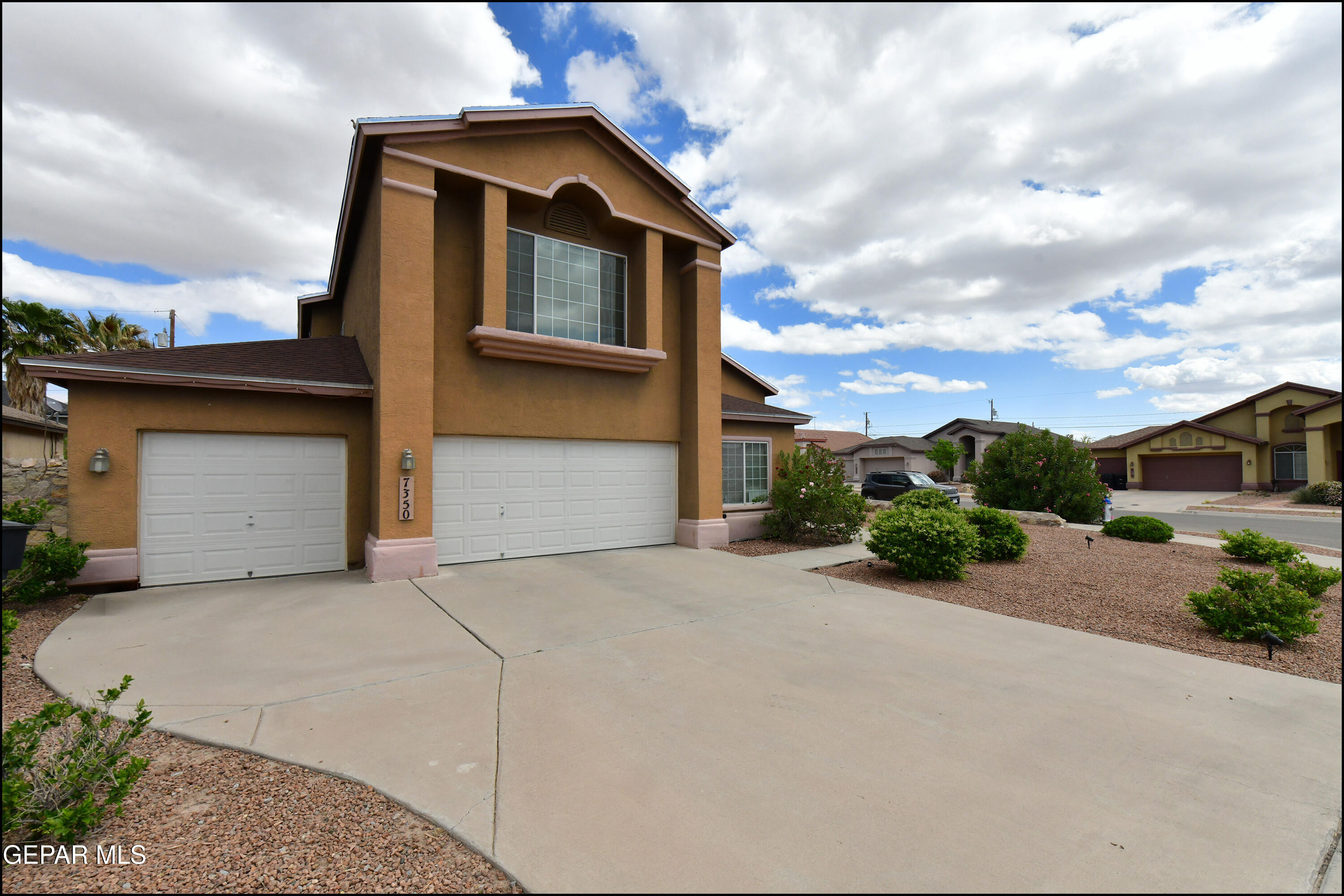 7350 Navidad Way Canutillo, TX 79835 - Photo 3 of 49 a front view of a house with a yard and garage
