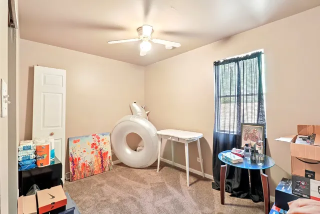a spacious bedroom with a bed and a chandelier