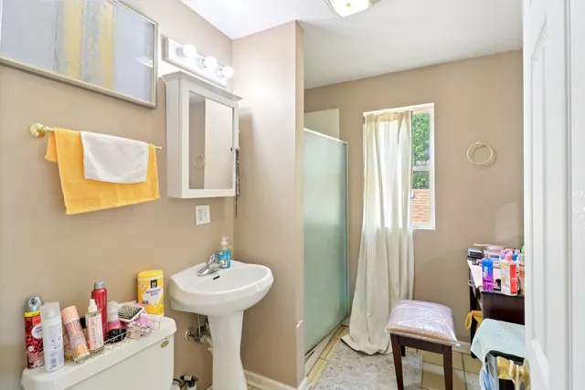 a bathroom with a sink mirror and a toilet