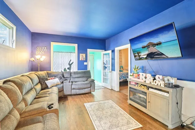 a living room with furniture and a flat screen tv