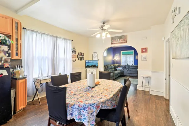 a view of a dining room with furniture a chandelier and wooden floor