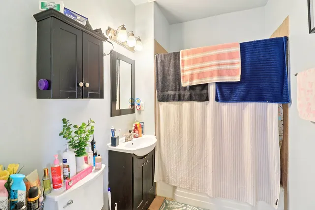 a bathroom with a sink vanity and mirror