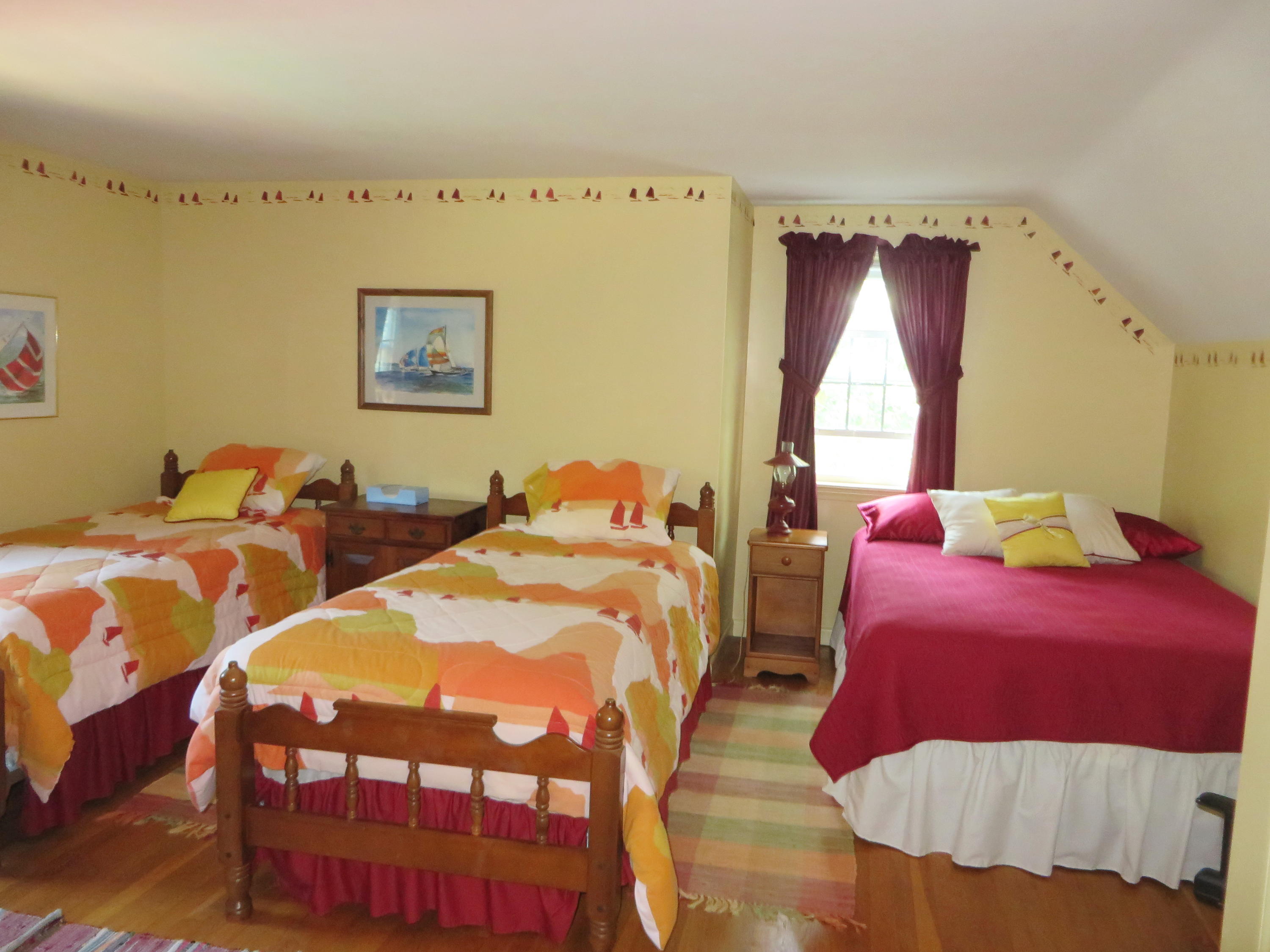 51 Monomoy Road Harwich Port, MA 02646 - Photo 14 of 19 a bedroom with two beds and a painting on the wall