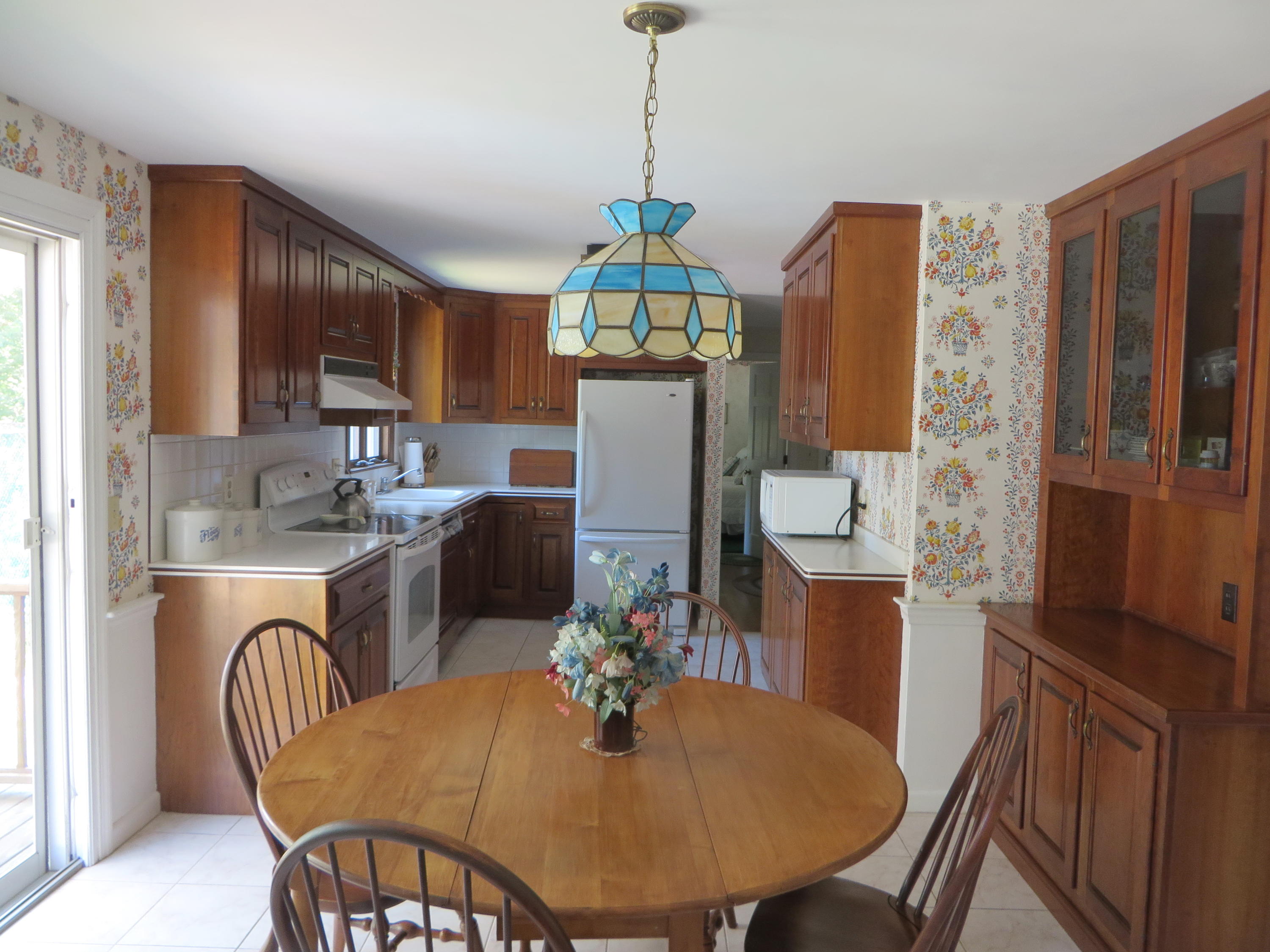 51 Monomoy Road Harwich Port, MA 02646 - Photo 6 of 19 a dining room with furniture a chandelier and window