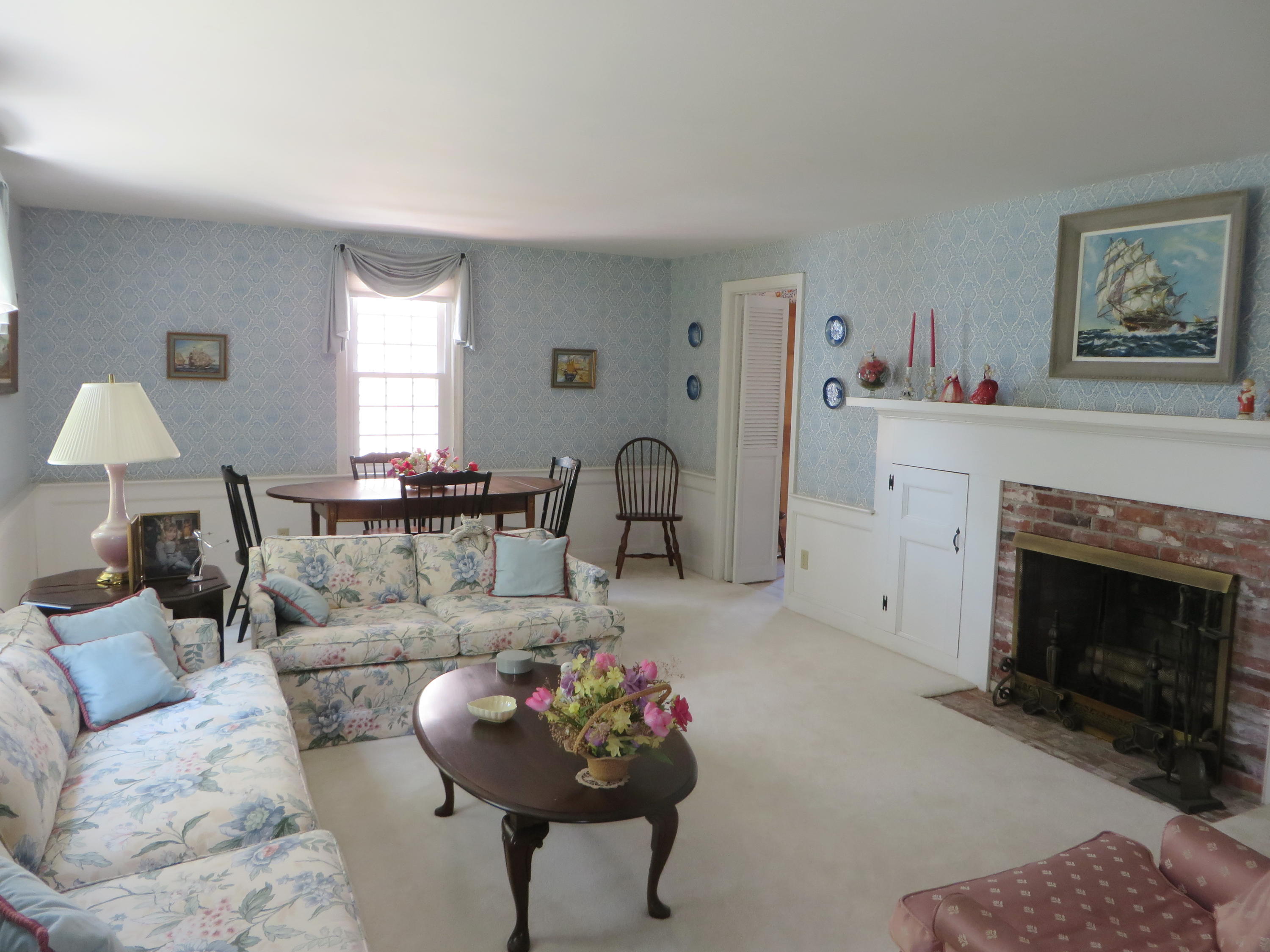 51 Monomoy Road Harwich Port, MA 02646 - Photo 8 of 19 a living room with furniture and a fireplace