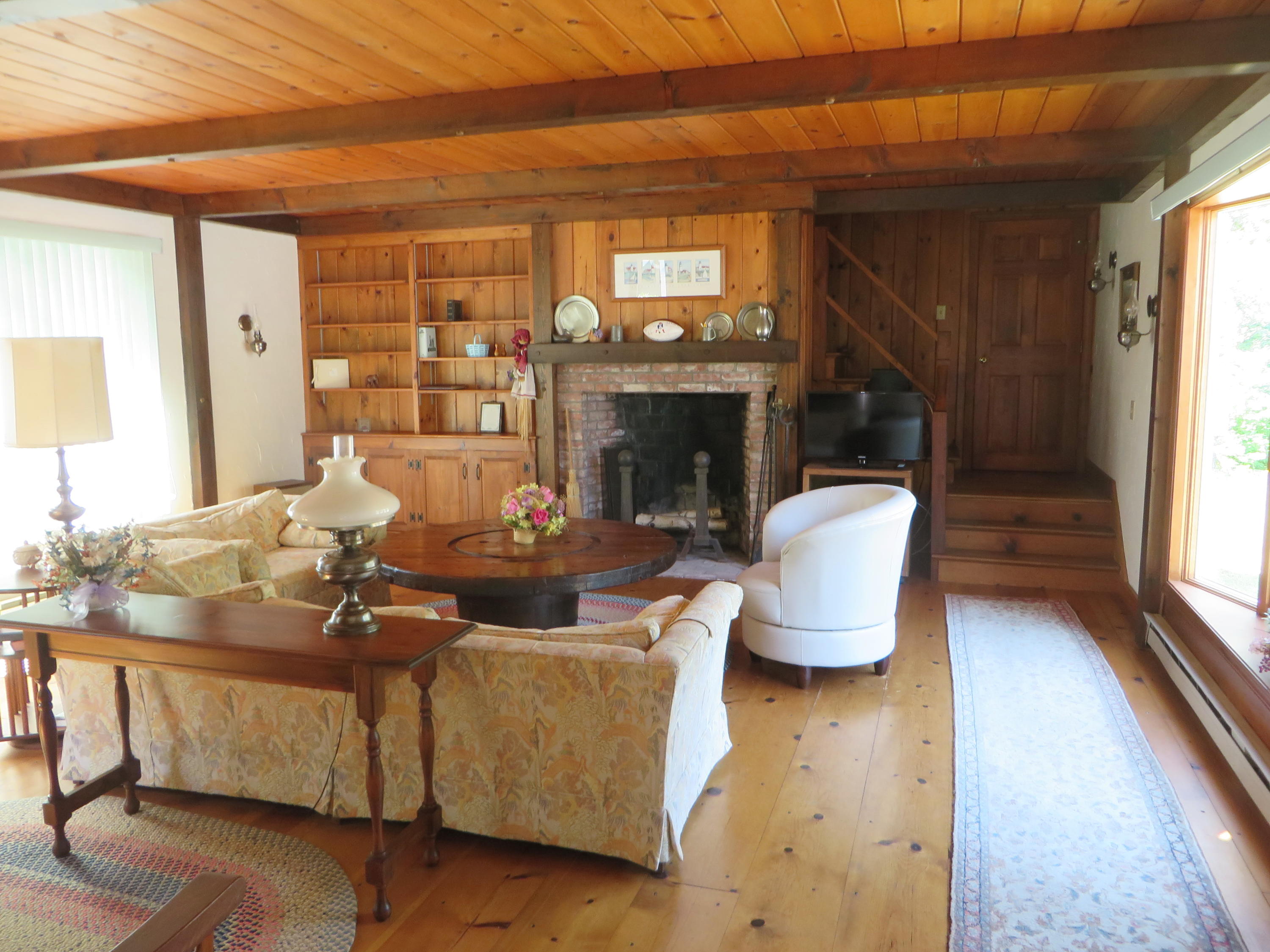 51 Monomoy Road Harwich Port, MA 02646 - Photo 9 of 19 a living room with fireplace furniture and a wooden floor