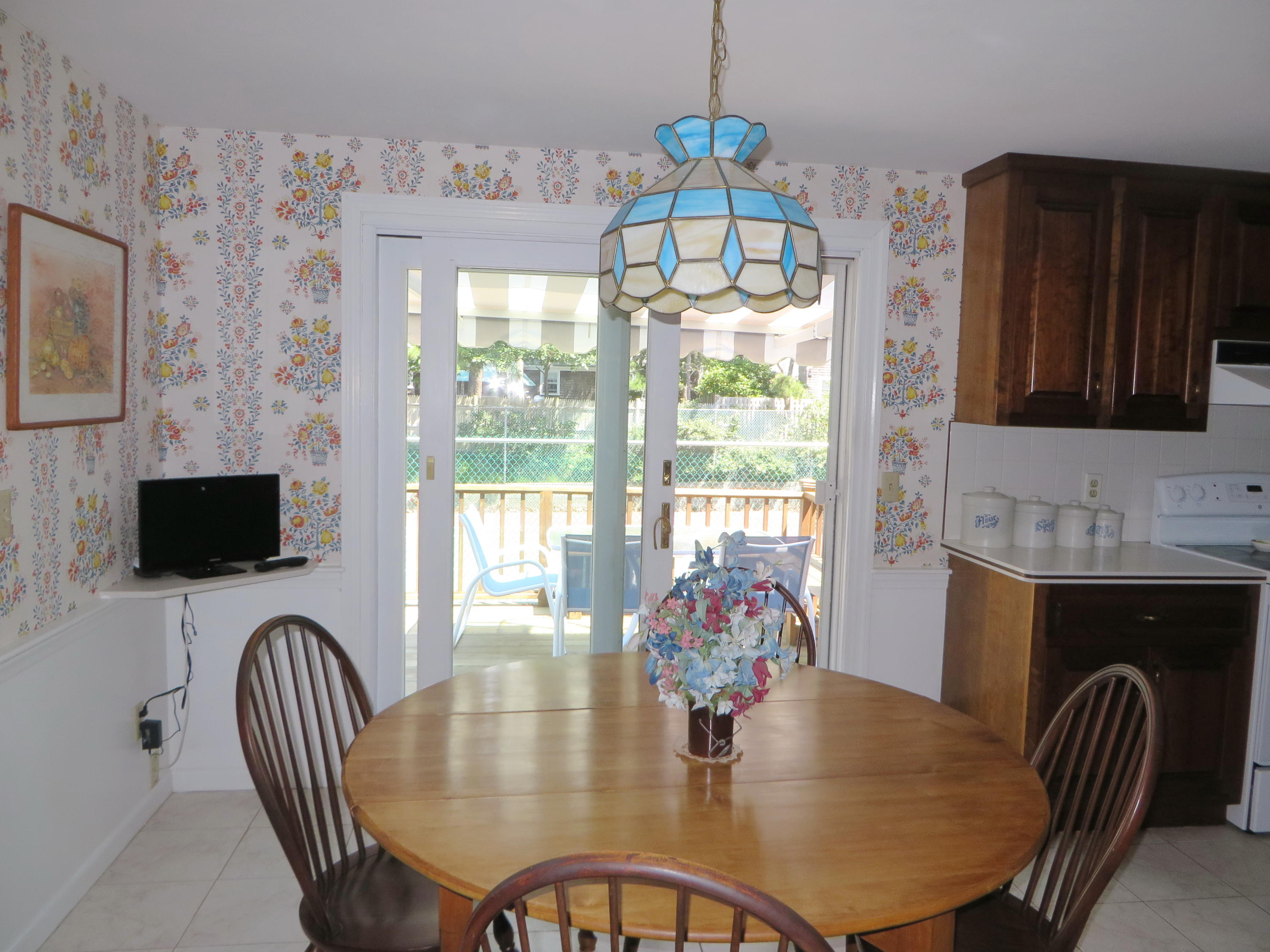 51 Monomoy Road Harwich Port, MA 02646 - Photo 10 of 19 a dining room with furniture a chandelier and window