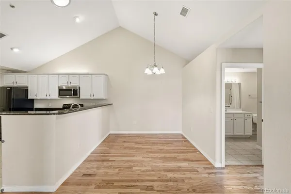 a kitchen with stainless steel appliances a refrigerator and a stove top oven
