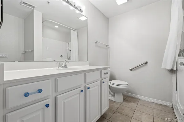 a bathroom with a sink toilet and a mirror
