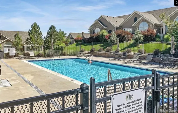 a view of a patio with a table and chairs under an umbrella