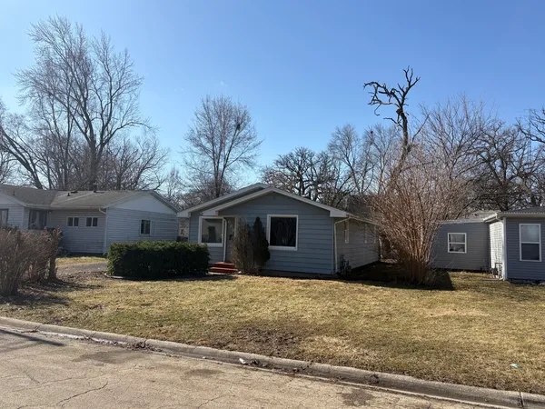 a house that has a tree in front of it