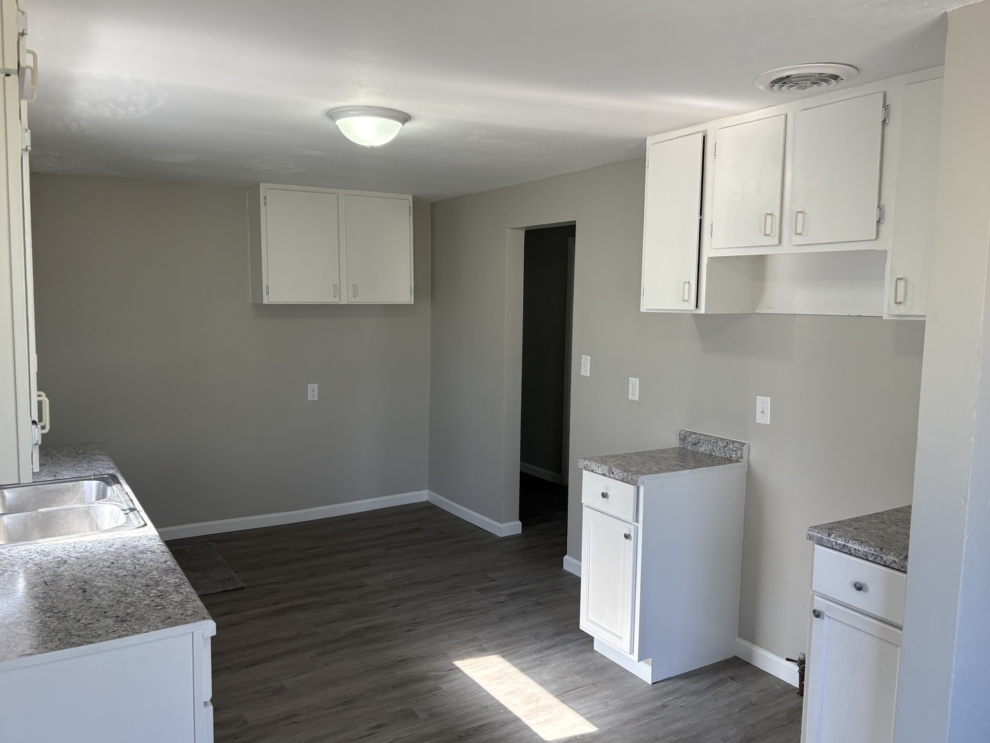 689 Country Club Drive Kankakee, IL 60901 - Photo 2 of 9 a kitchen with granite countertop white cabinets and a sink