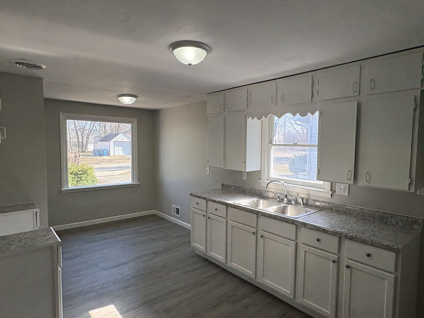 689 Country Club Drive Kankakee, IL 60901 - Photo 3 of 9 a kitchen with granite countertop a sink window and cabinets