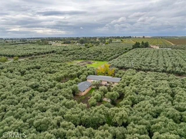 an aerial view of a house with a yard and garden