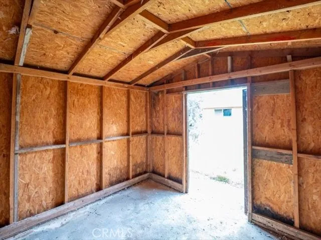 a view of an empty room with wooden walls