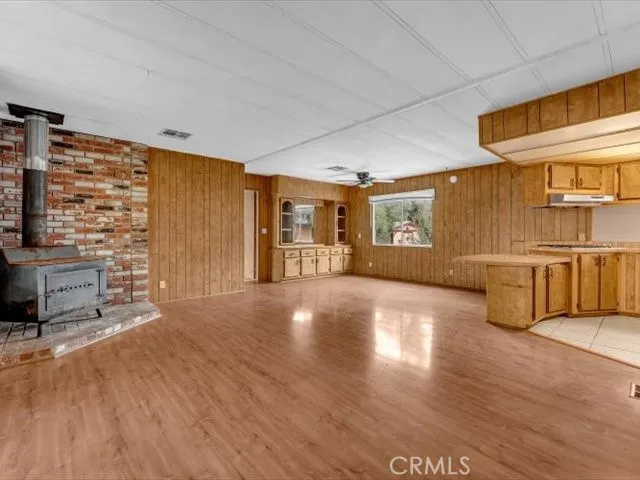 a large room with a large window and wooden floor