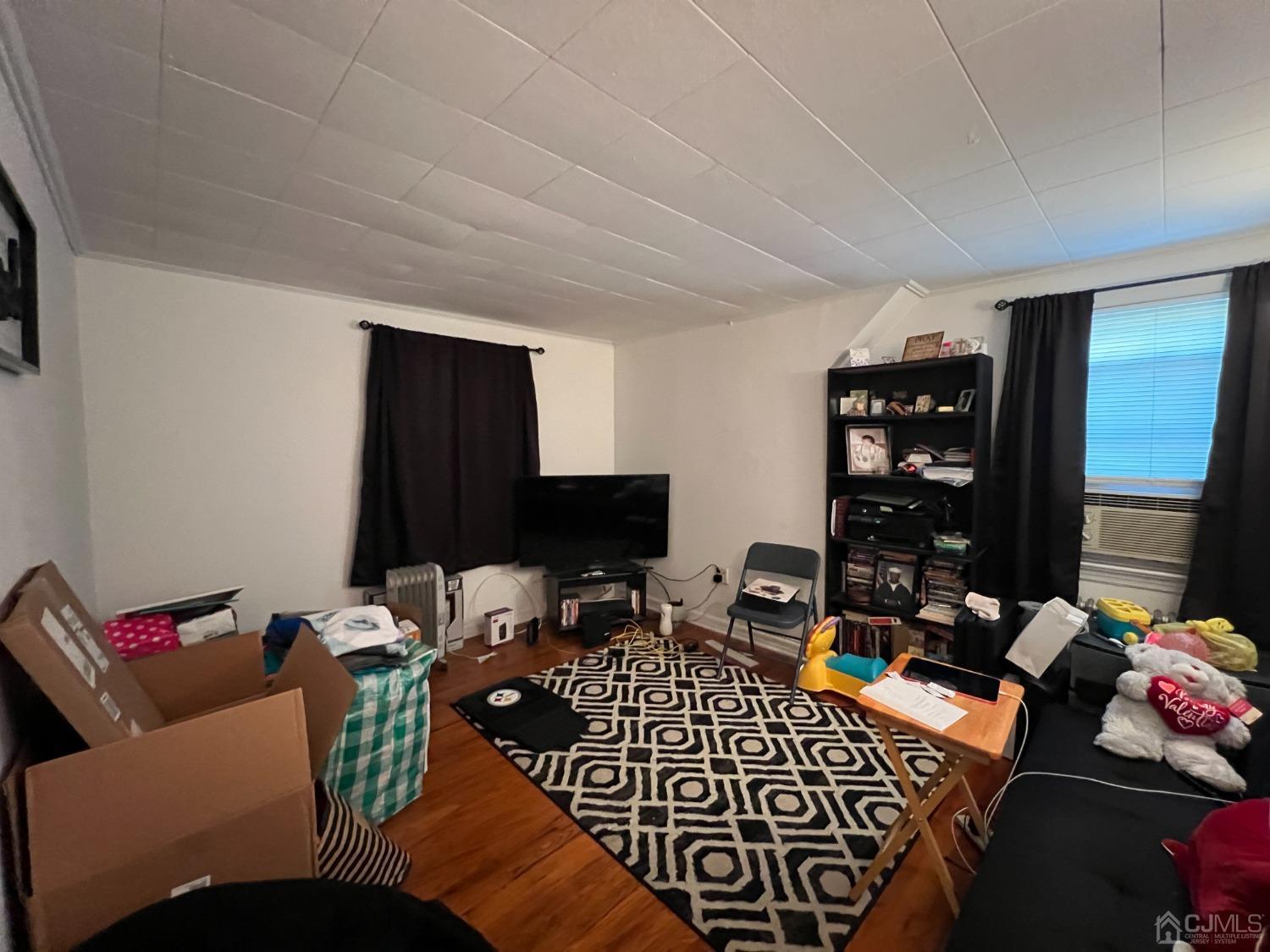 48 Riverview Avenue Edison, NJ 08817 - Photo 16 of 19 a room with furniture a rug and a window