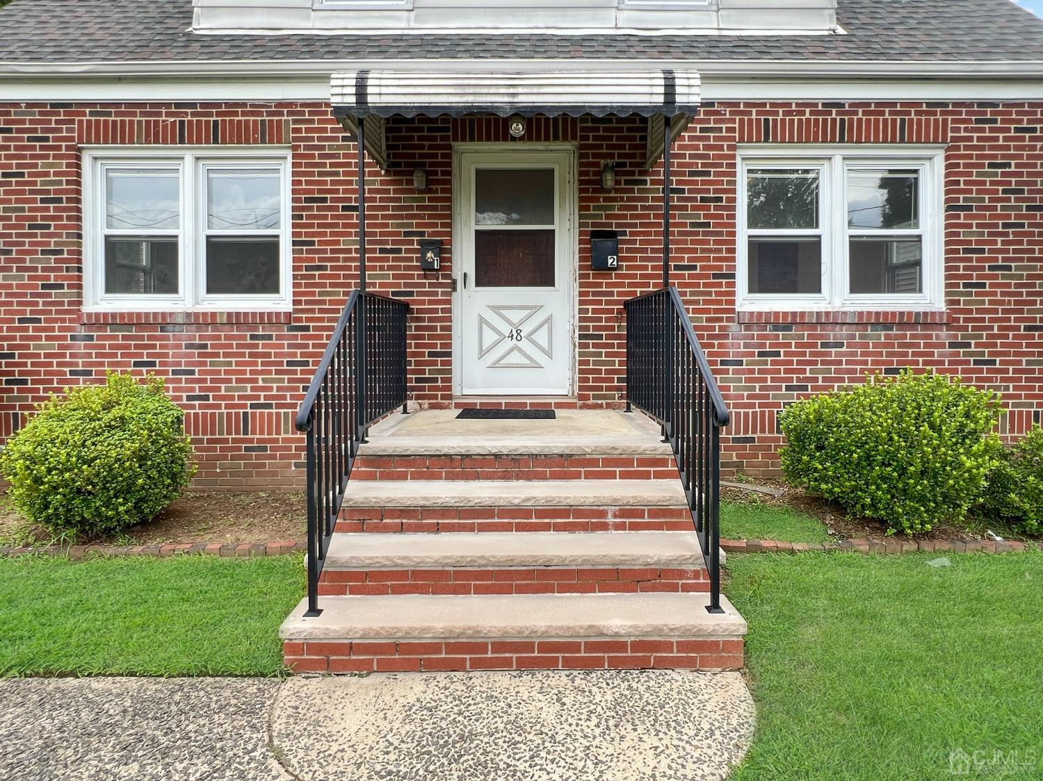 48 Riverview Avenue Edison, NJ 08817 - Photo 2 of 19 a front view of a house with a garden