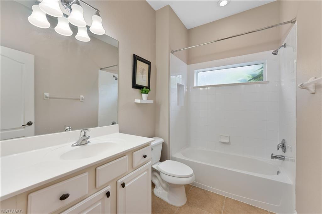 15322 Cortona Way Naples, FL 34120 - Photo 12 of 26 a bathroom with a sink a toilet and shower