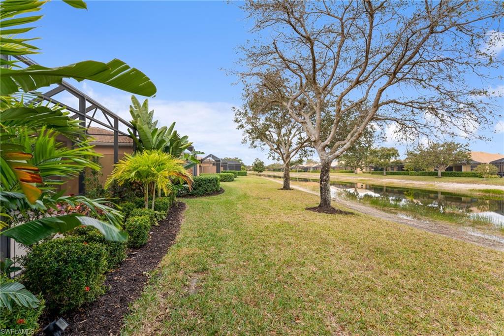15322 Cortona Way Naples, FL 34120 - Photo 15 of 26 a view of a lake with houses