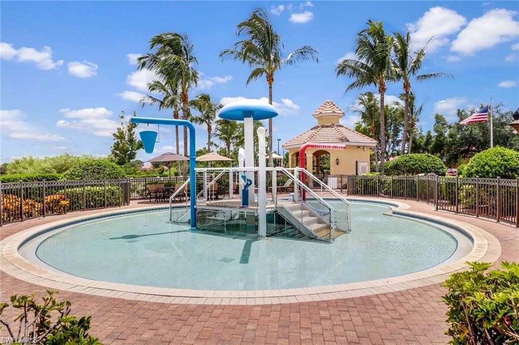 15322 Cortona Way Naples, FL 34120 - Photo 19 of 26 a view of a swimming pool with a patio