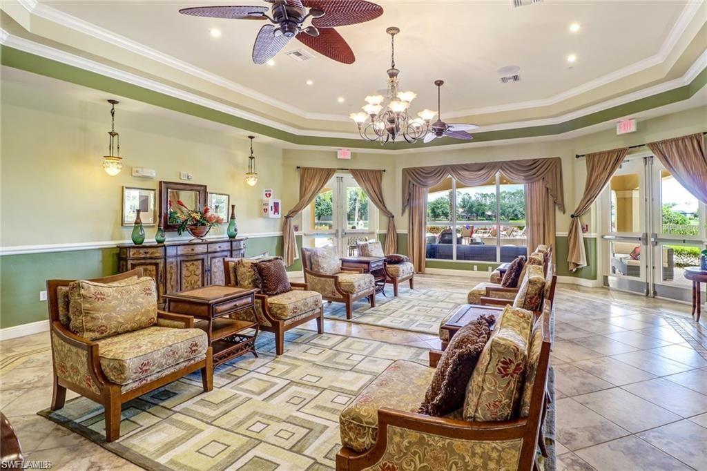 15322 Cortona Way Naples, FL 34120 - Photo 25 of 26 a living room with furniture a chandelier and a large window