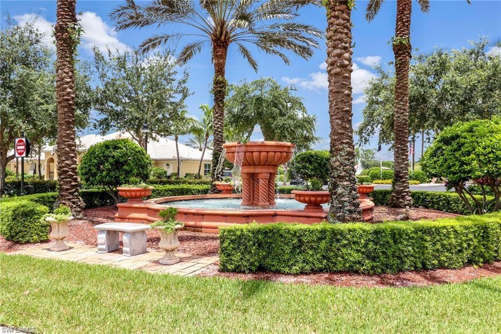 15322 Cortona Way Naples, FL 34120 - Photo 26 of 26 a view of a swimming pool with lawn chairs and a fire pit