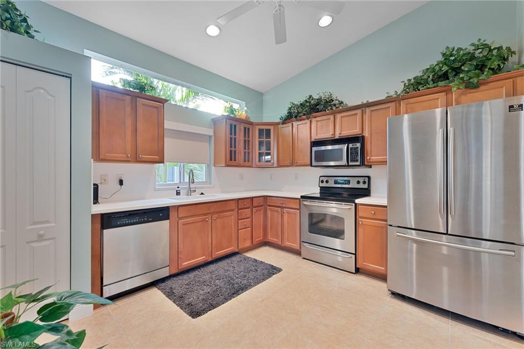 15322 Cortona Way Naples, FL 34120 - Photo 5 of 26 a kitchen with stainless steel appliances granite countertop a refrigerator sink and stove