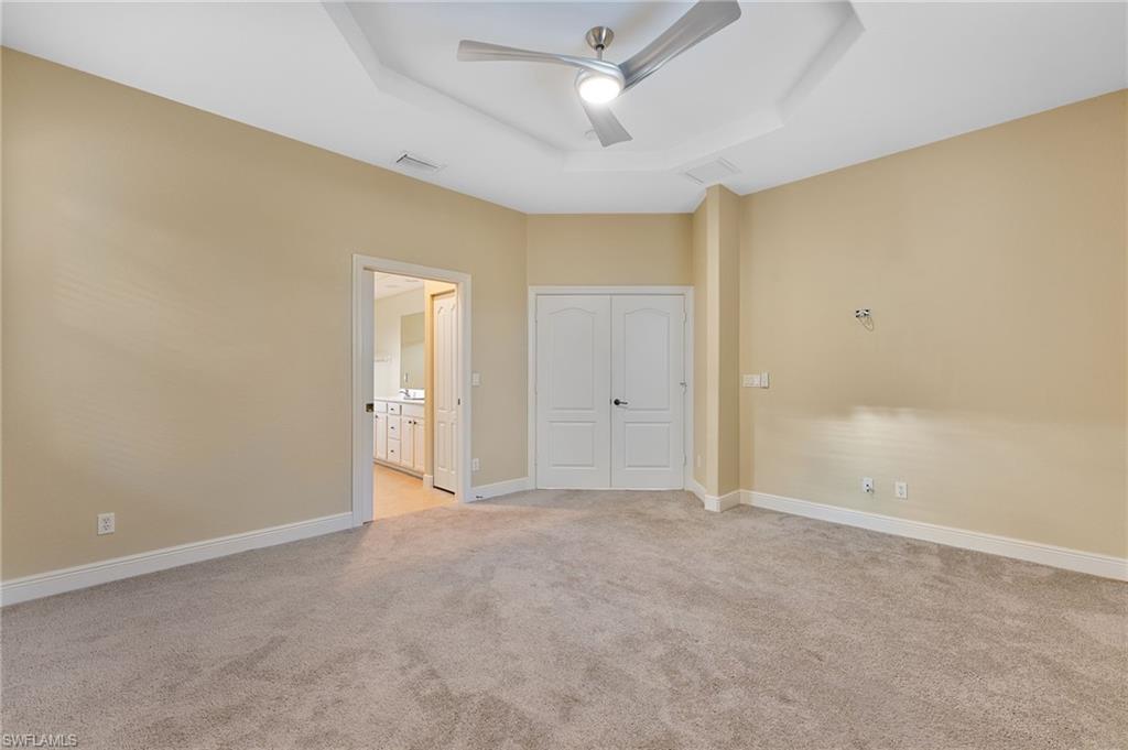 15322 Cortona Way Naples, FL 34120 - Photo 7 of 26 an empty room with a ceiling fan and a window