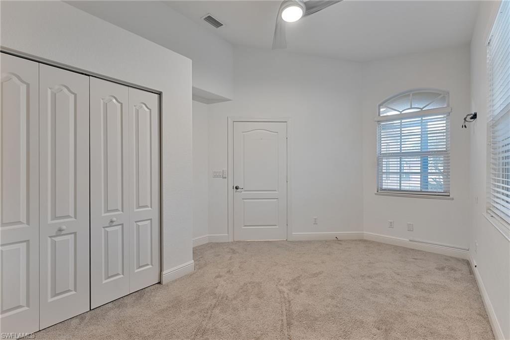 15322 Cortona Way Naples, FL 34120 - Photo 9 of 26 an empty room with windows