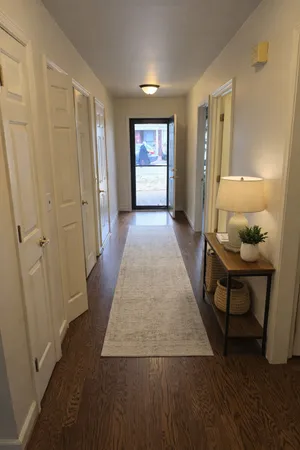a view of a room with wooden floor and window