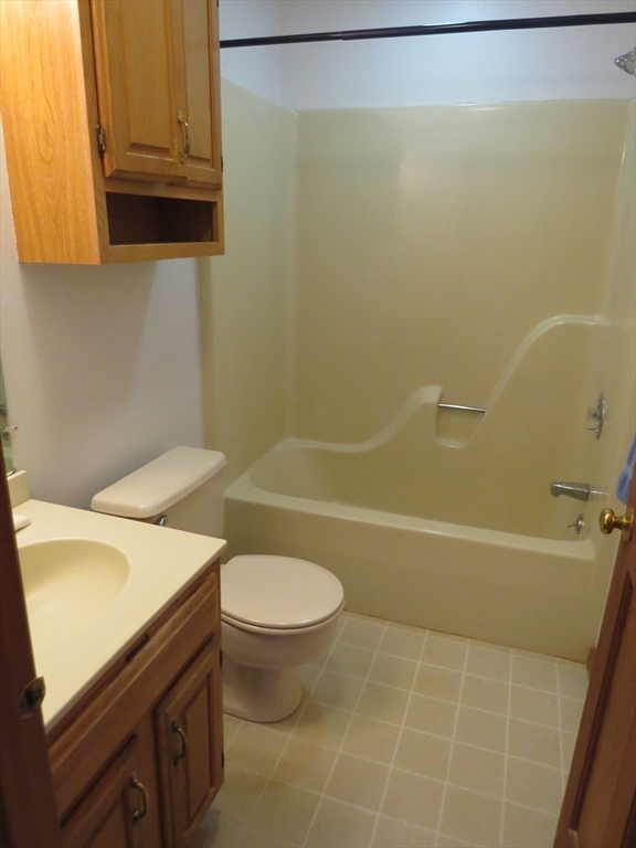 5 B Pond View Way, Unit 5B Northborough, MA 01532 - Photo 14 of 16 a bathroom with a sink a toilet and bathtub