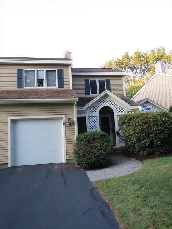 5 B Pond View Way, Unit 5B Northborough, MA 01532 - Photo 15 of 16 a front view of a house with a yard and garage