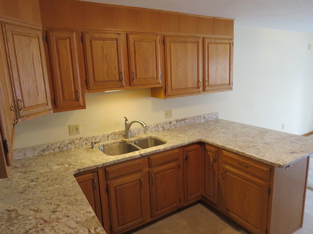 5 B Pond View Way, Unit 5B Northborough, MA 01532 - Photo 4 of 16 a kitchen with a sink and cabinets