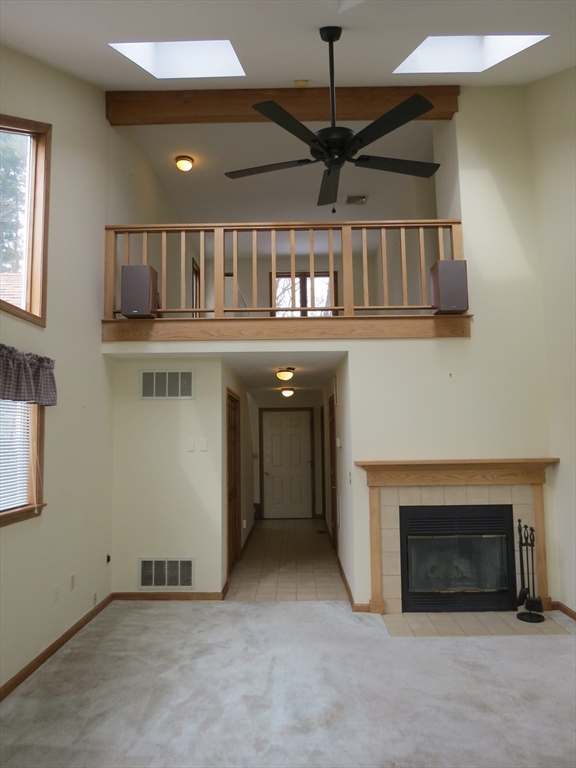 5 B Pond View Way, Unit 5B Northborough, MA 01532 - Photo 5 of 16 an empty room with windows dryer and fireplace