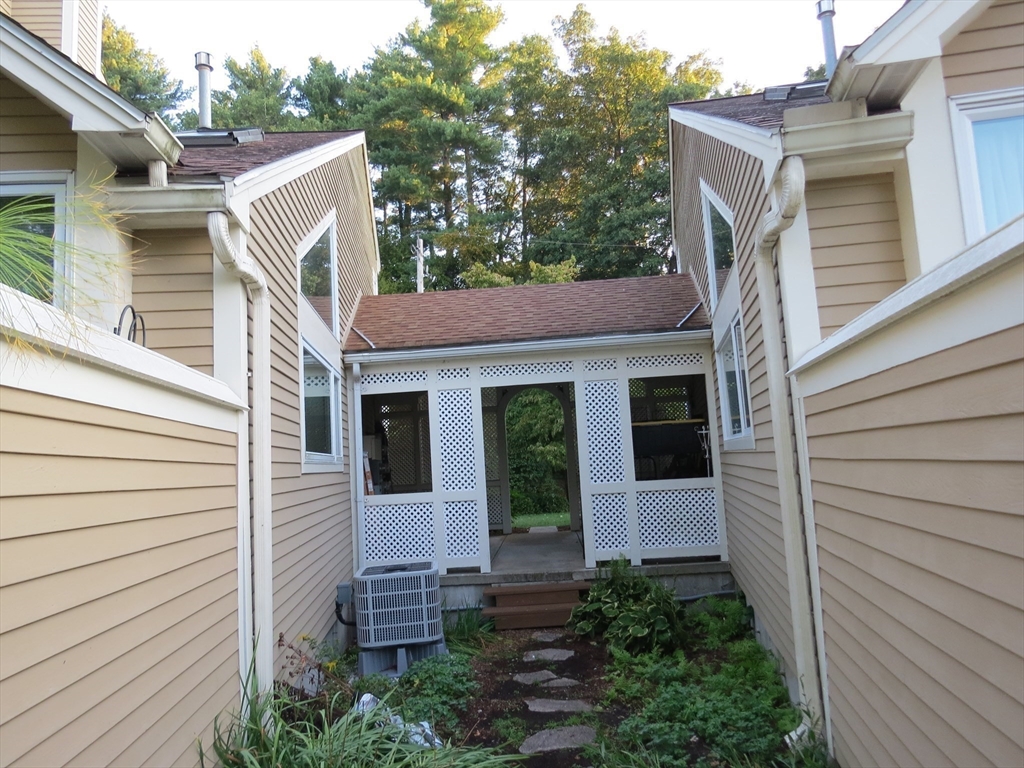 5 B Pond View Way, Unit 5B Northborough, MA 01532 - Photo 8 of 16 a view of a white house with a small garden