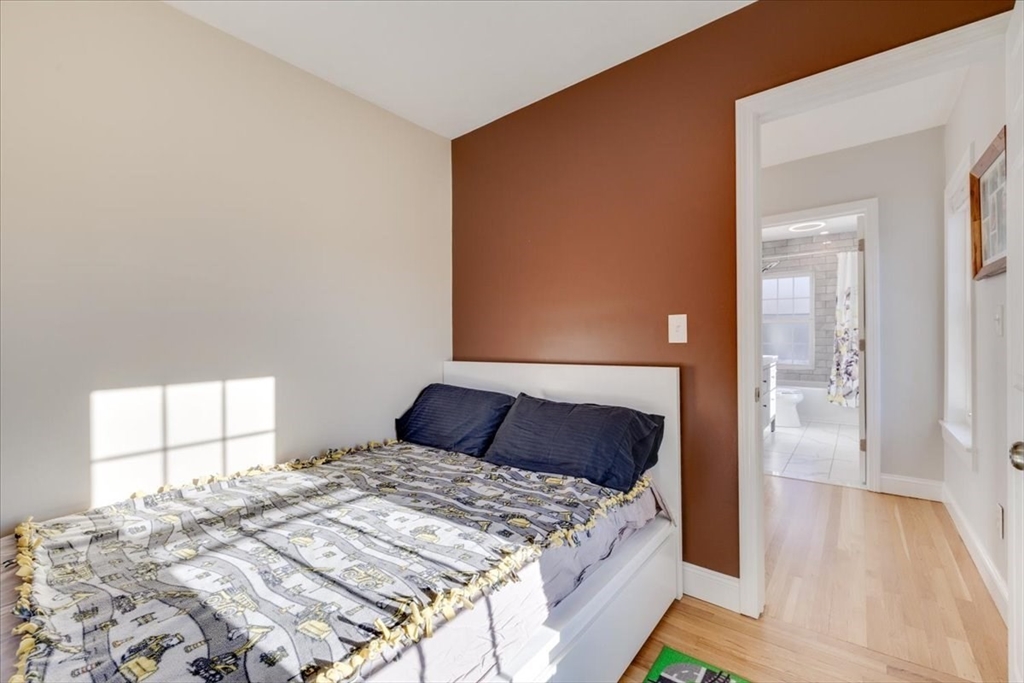 1 Bennett Street Natick, MA 01760 - Photo 14 of 28 a bedroom with a bed and a window