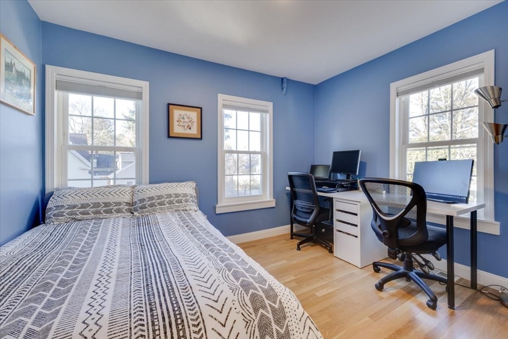 1 Bennett Street Natick, MA 01760 - Photo 15 of 28 a bedroom with a bed a table chair and a window