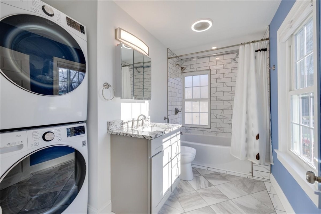 1 Bennett Street Natick, MA 01760 - Photo 20 of 28 a bathroom with a sink a toilet and shower