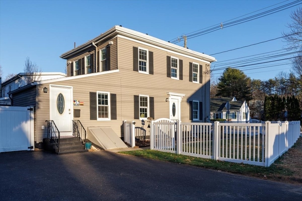 1 Bennett Street Natick, MA 01760 - Photo 23 of 28 a front view of a house with a yard
