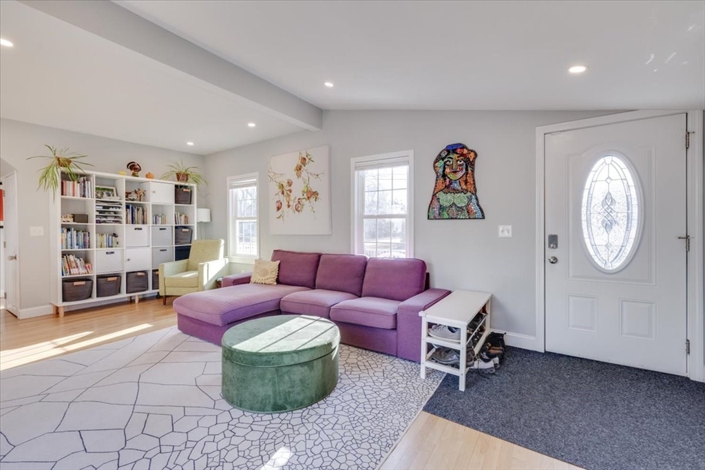 1 Bennett Street Natick, MA 01760 - Photo 5 of 28 a living room with furniture a bookshelf and a large window