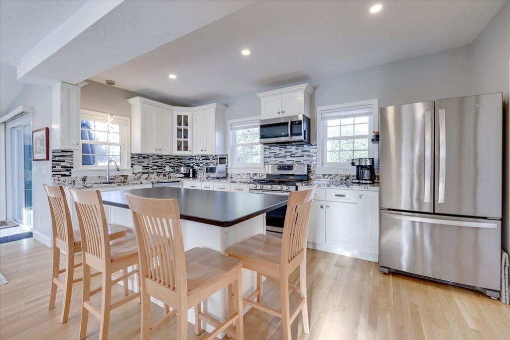 1 Bennett Street Natick, MA 01760 - Photo 8 of 28 a kitchen with stainless steel appliances granite countertop a refrigerator a stove top oven a sink dishwasher and a refrigerator