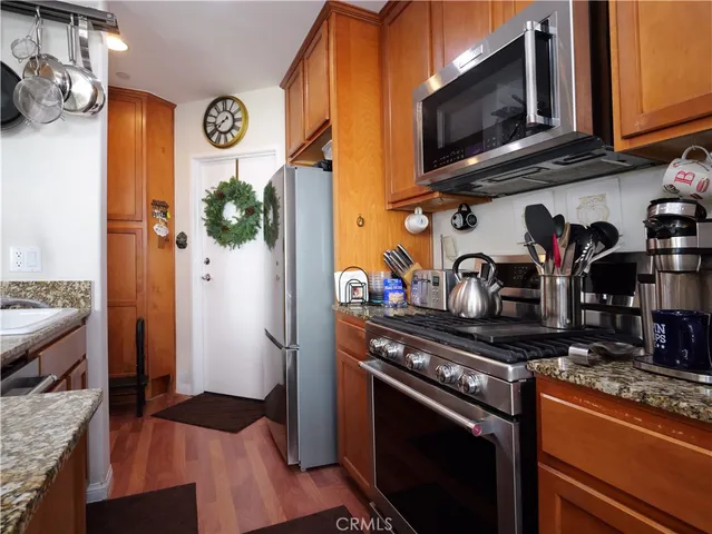 a kitchen with stainless steel appliances granite countertop a stove and a microwave