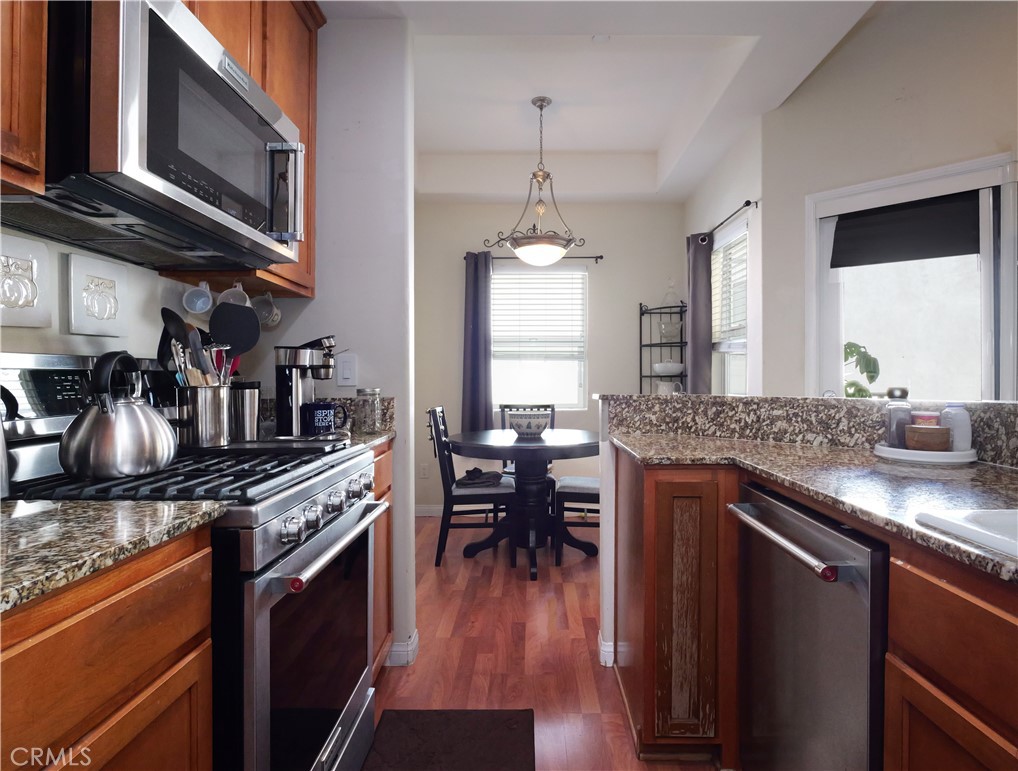 1323 Post Avenue, Unit K Torrance, CA 90501 - Photo 6 of 23 a kitchen with stainless steel appliances granite countertop a stove and a wooden floors