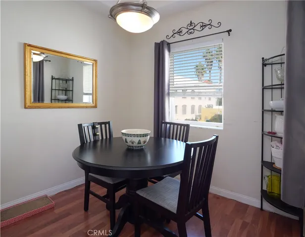 a view of a dining room with furniture wooden floor and a window