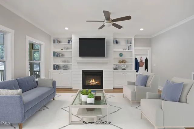 a living room with furniture a flat screen tv and a fireplace