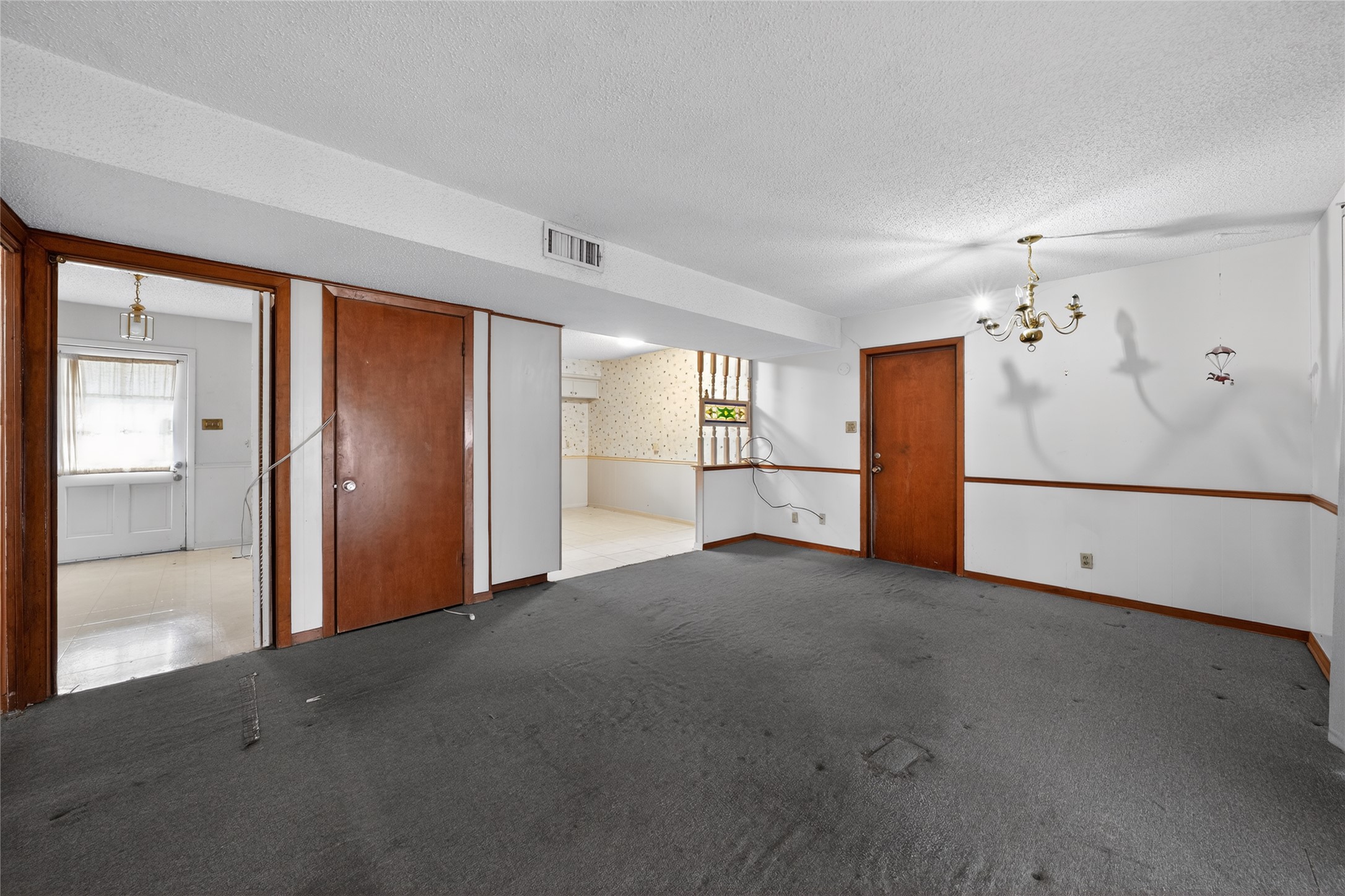 2112 Vanderbilt Lane Austin, TX 78723 - Photo 6 of 23 an empty room with a cabinet and a refrigerator