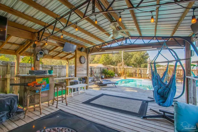 a living room with lots of furniture a rug and white walls