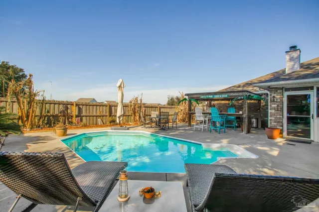 a view of a porch with a table and chairs and potted plants